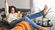 Woman getting excited looking at her smartphone with her arm up and kicking her legs